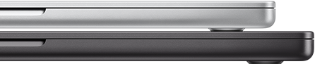 Closed 14-inch MacBook Pro in Silver finish, stacked on closed 16-inch MacBook Pro in Space Black finish